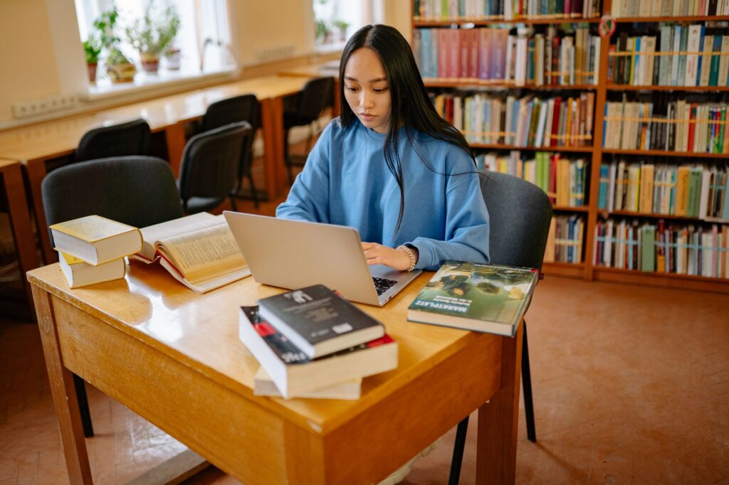 Student using Google NotebookLM AI research tool on laptop