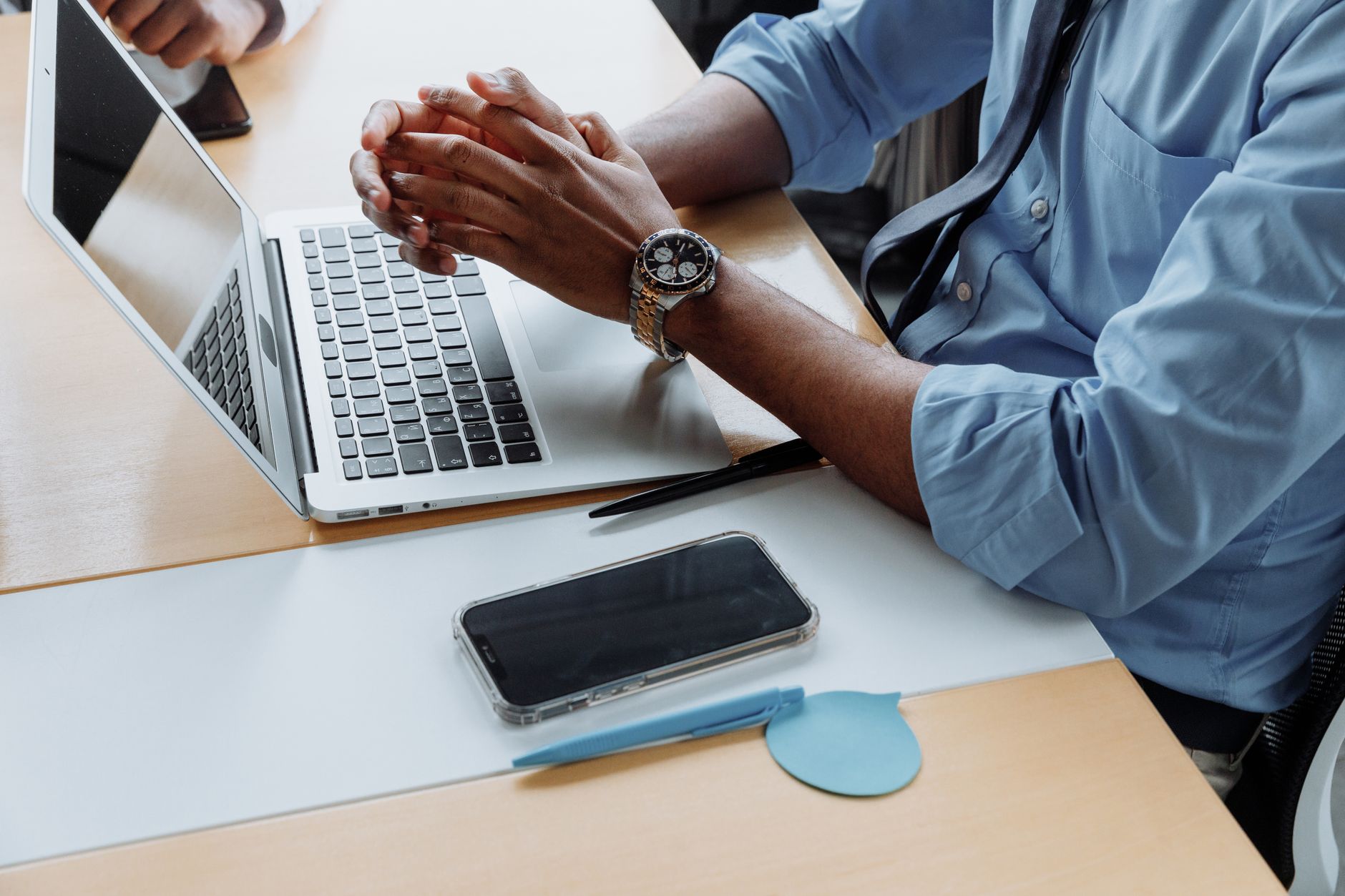 Business professional using AI automation tools on laptop in office