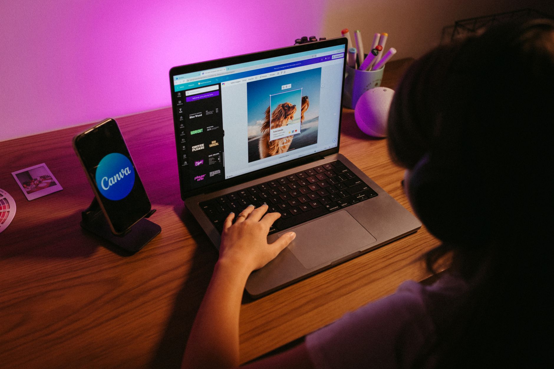 Teen using laptop for graphic design with Canva AI features
