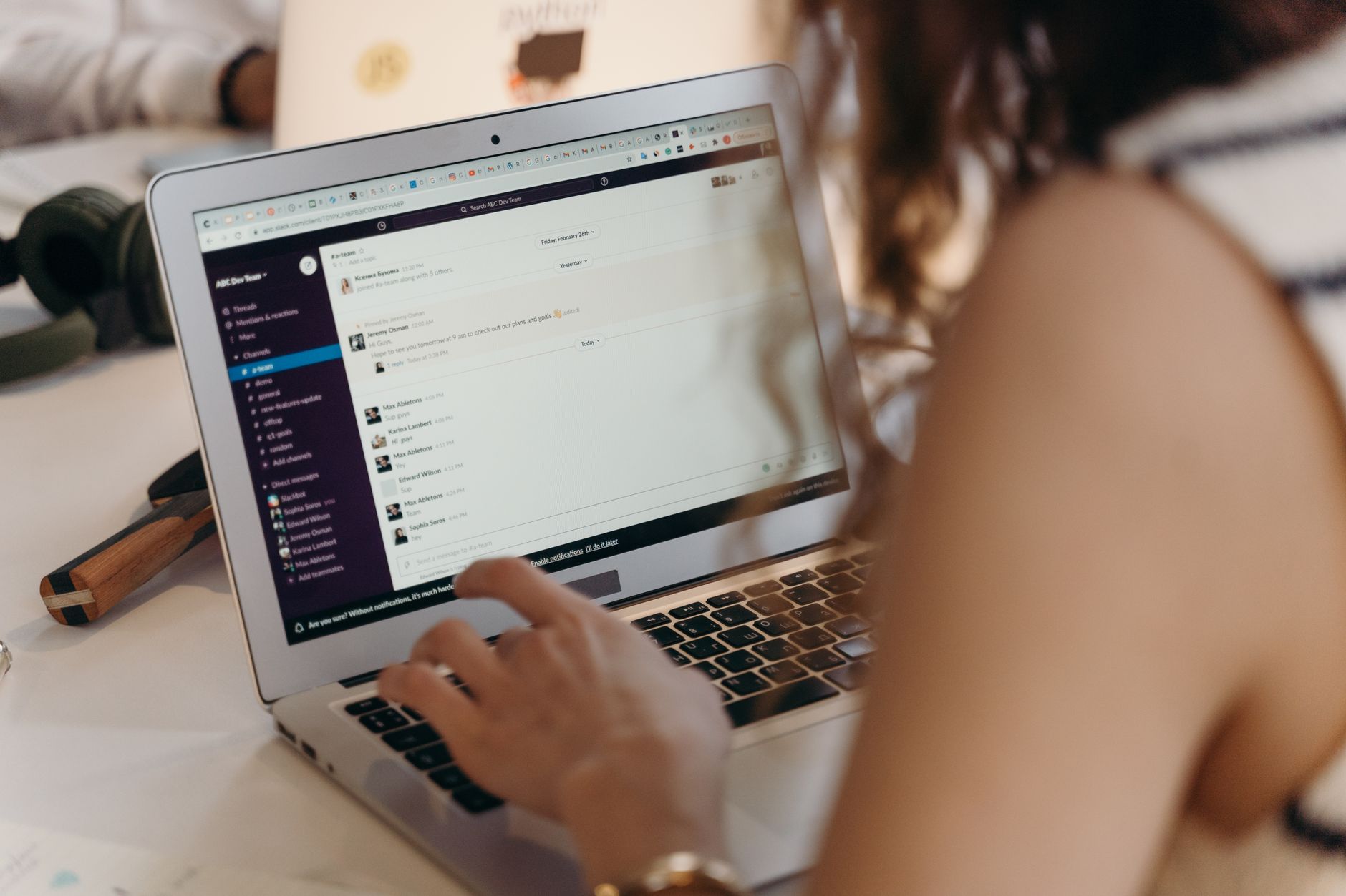 Businesswoman using email marketing software on laptop in office