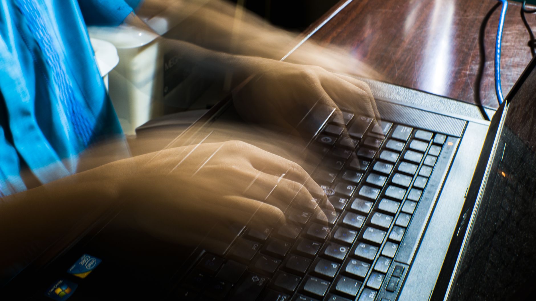 Developer working on laptop — setting up Cloudflare for website security and performance