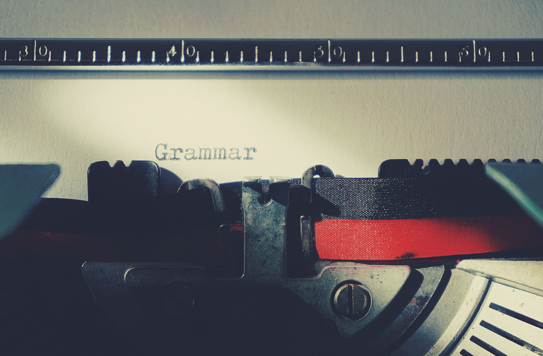 Vintage typewriter showing the word Grammar representing grammar and writing tools