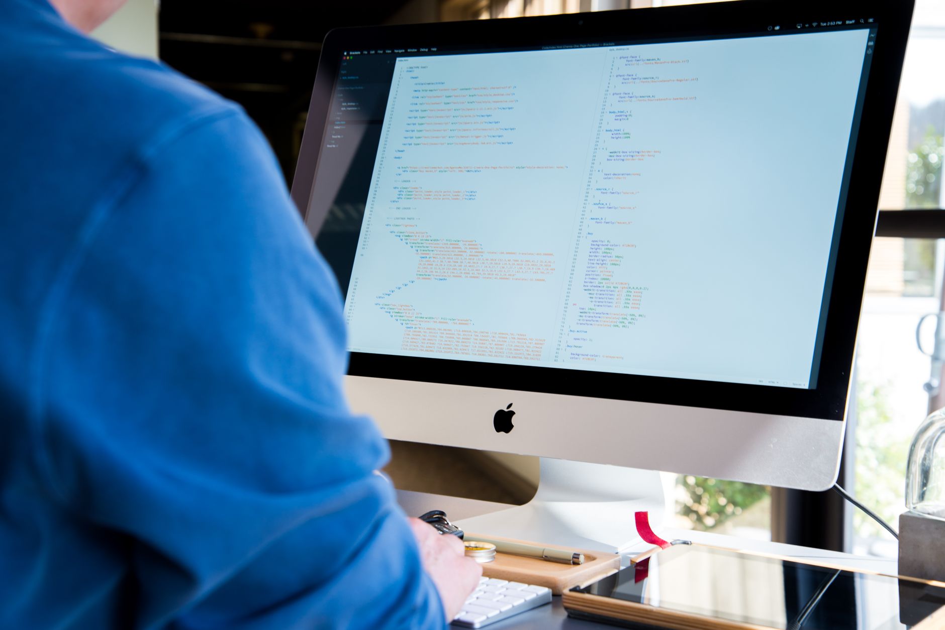Best Free AI Coding Assistants for Indian Developers in 2026: Cursor vs Codeium vs Tabnine vs Copilot Programmer coding on iMac using AI coding assistant