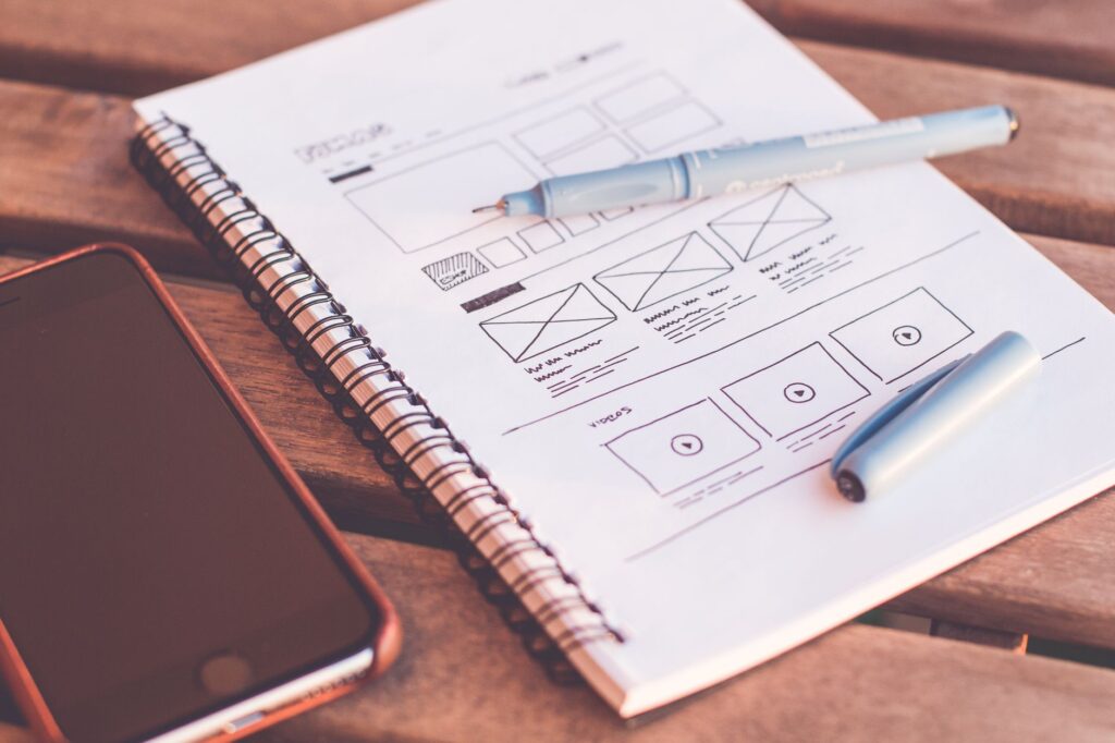 Figma vs Penpot in 2026: Which Design Tool Should Indian Developers and Designers Choose? Design wireframe sketches on notebook comparing Figma and Penpot tools