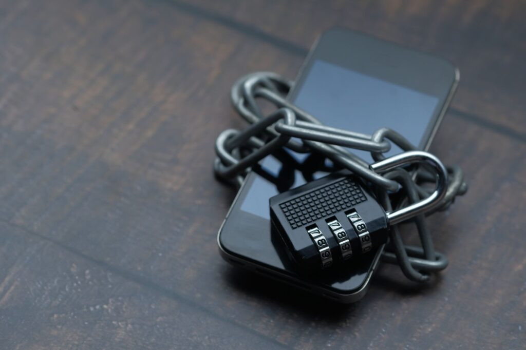 Smartphone wrapped in chain and padlock symbolising strong digital security and encryption