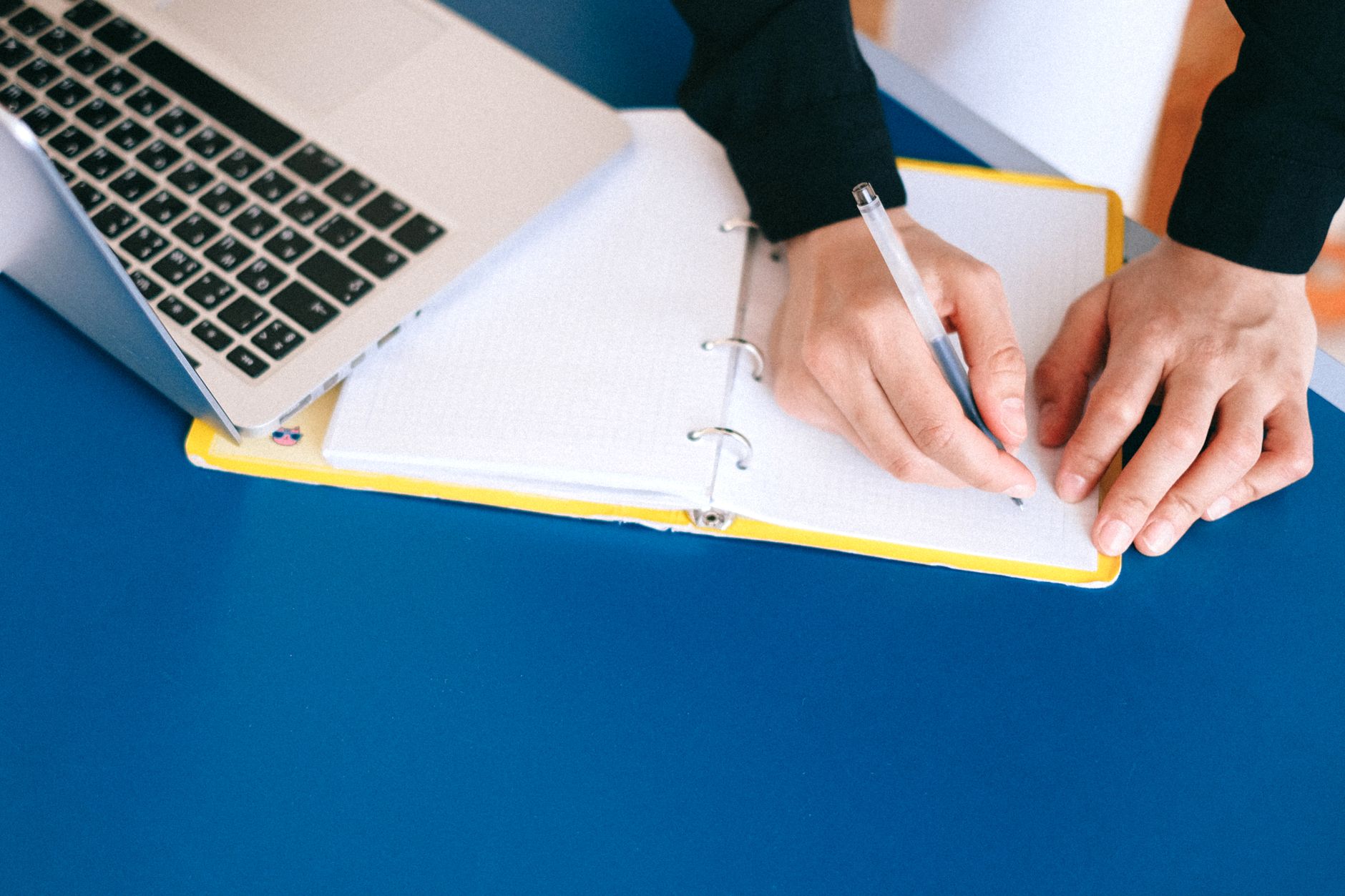 Best Free Note-Taking Apps in 2026: Obsidian vs Notion vs Logseq vs Joplin for Indian Students and Professionals Hands writing in a notebook alongside a laptop representing the shift from paper to digital note-taking apps