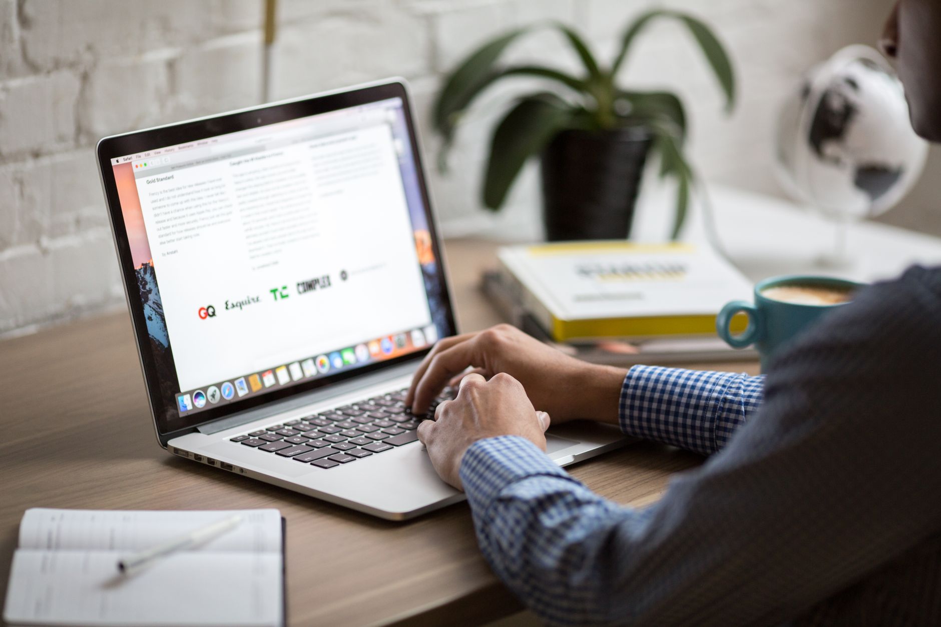 Man working on laptop reviewing email marketing analytics at desk - comparing email tools 2026