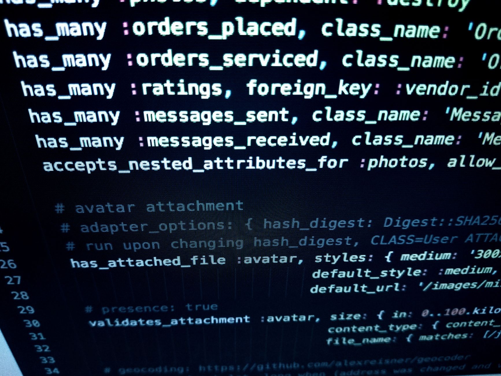Close-up image featuring detailed programming code on a computer screen representing automated deployment pipeline configuration