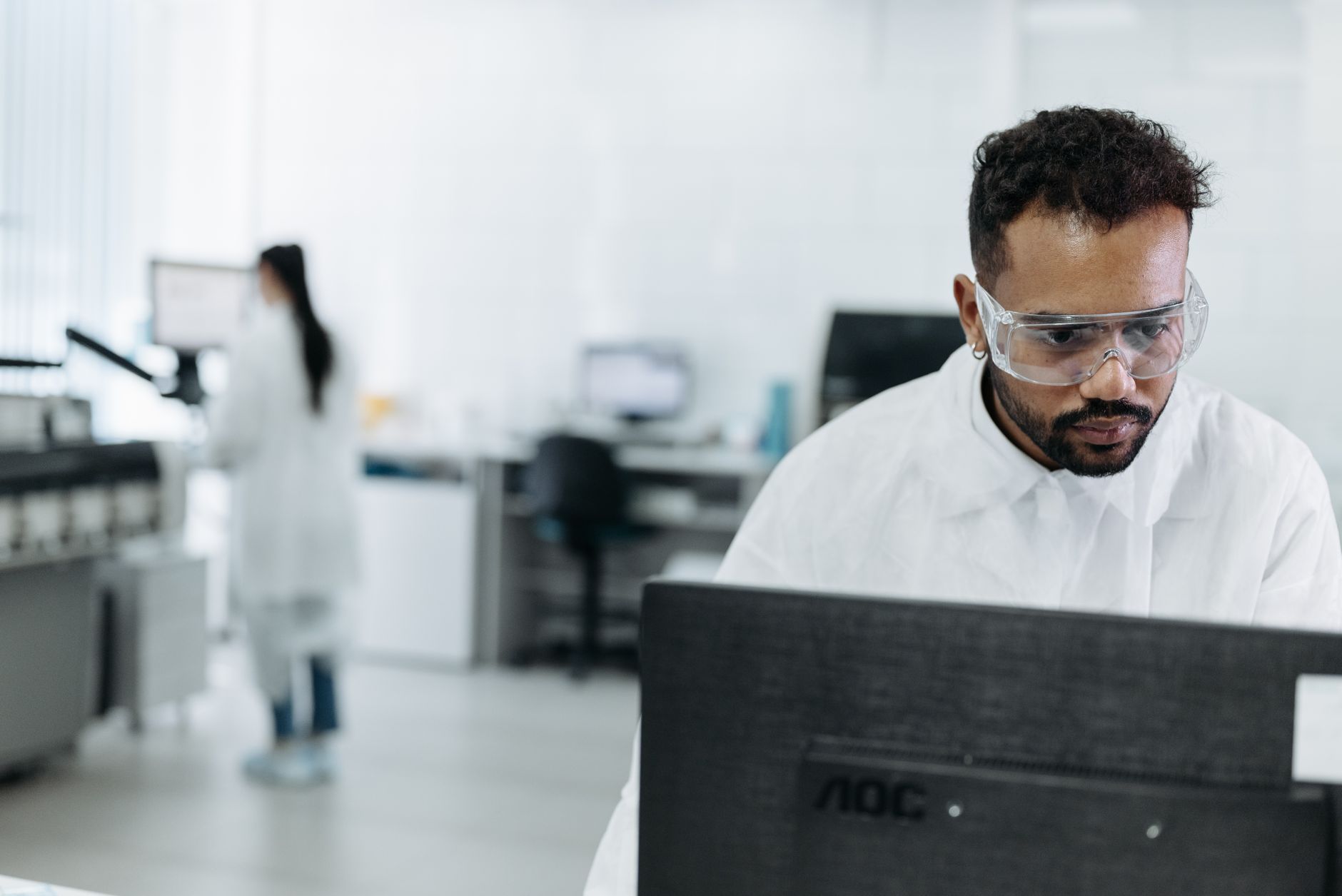 Scientist working at computer in laboratory conducting research using digital tools and AI software