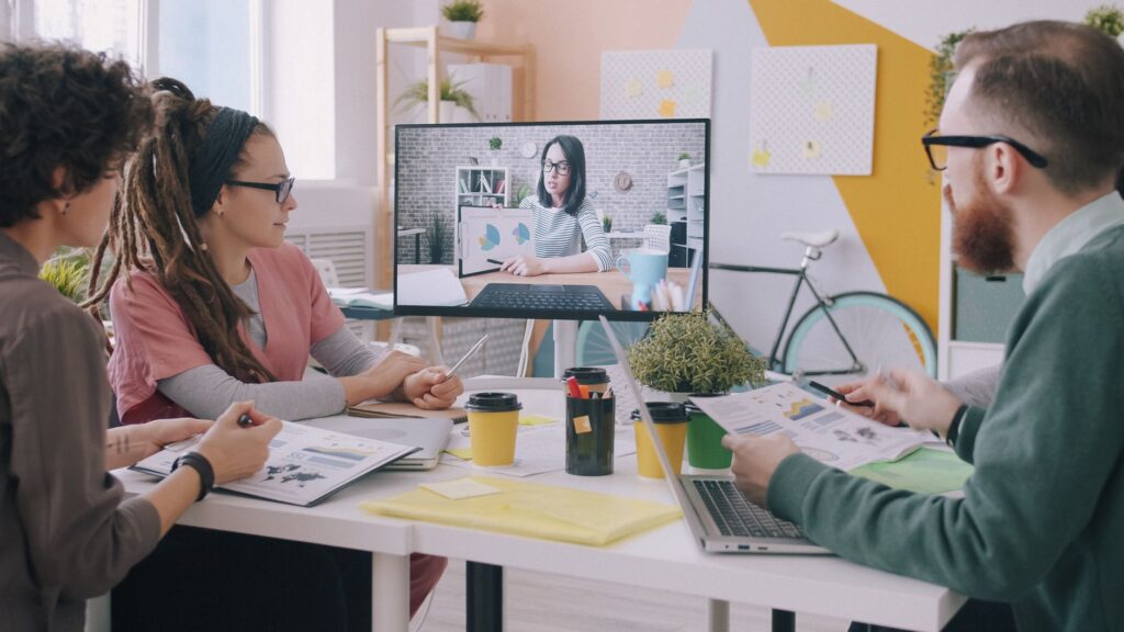 Creative team in modern office having video conference discussing cloud storage strategy for remote work