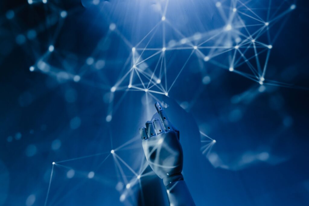 Robotic hand reaching into digital AI network representing artificial intelligence technology