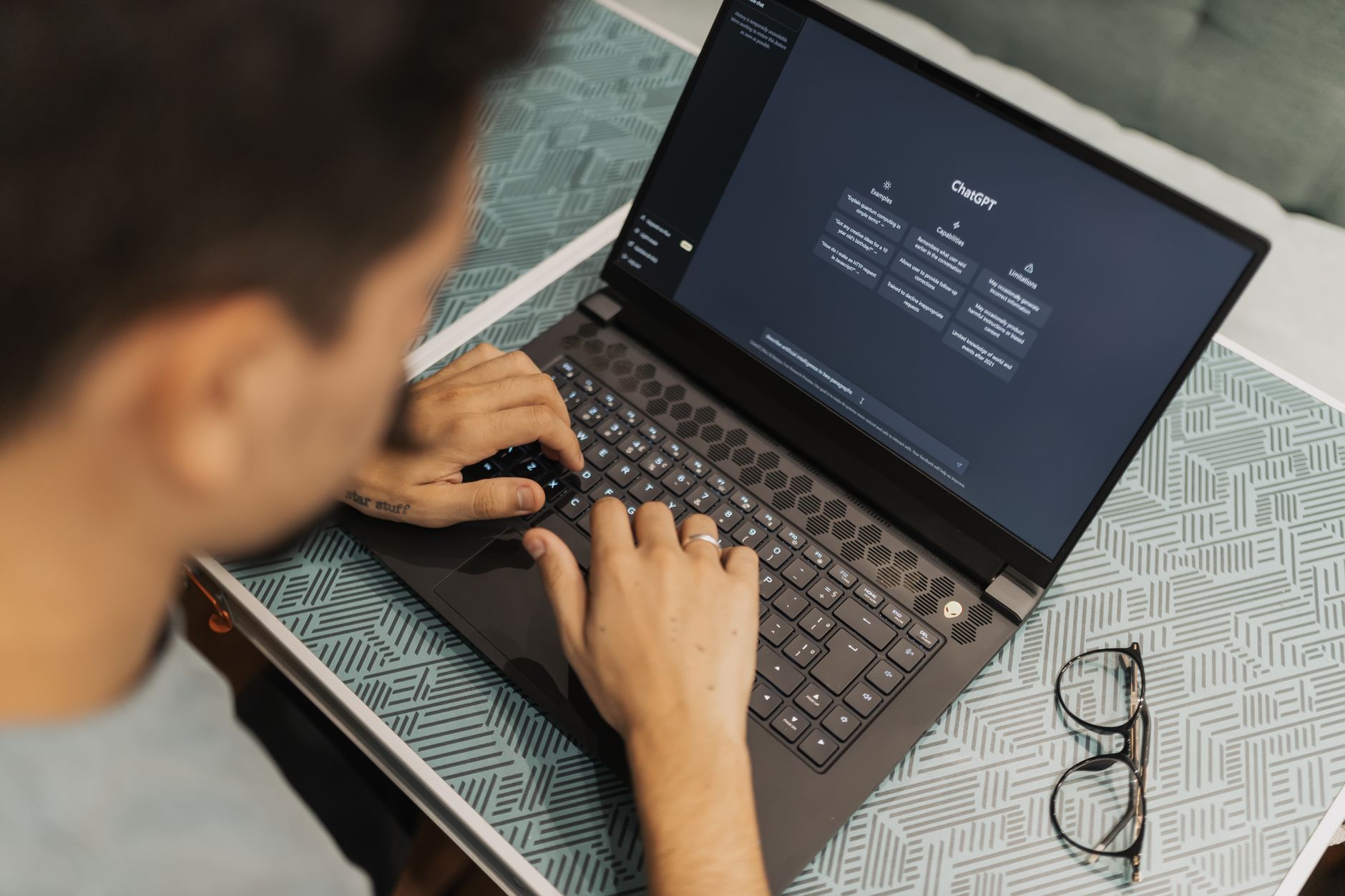 Professional using AI assistant on laptop for work productivity tasks