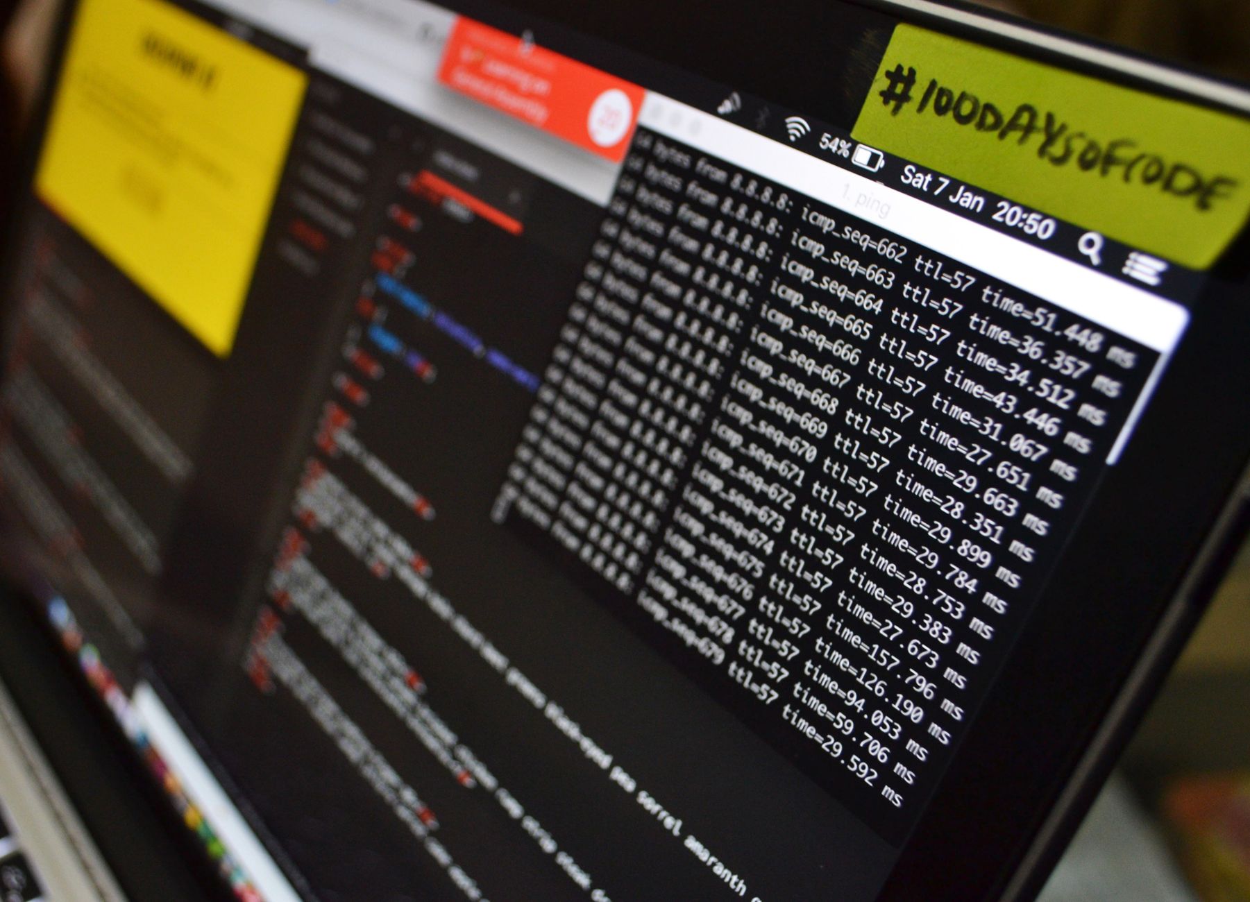 Macro shot of a developer laptop displaying code and data analysis