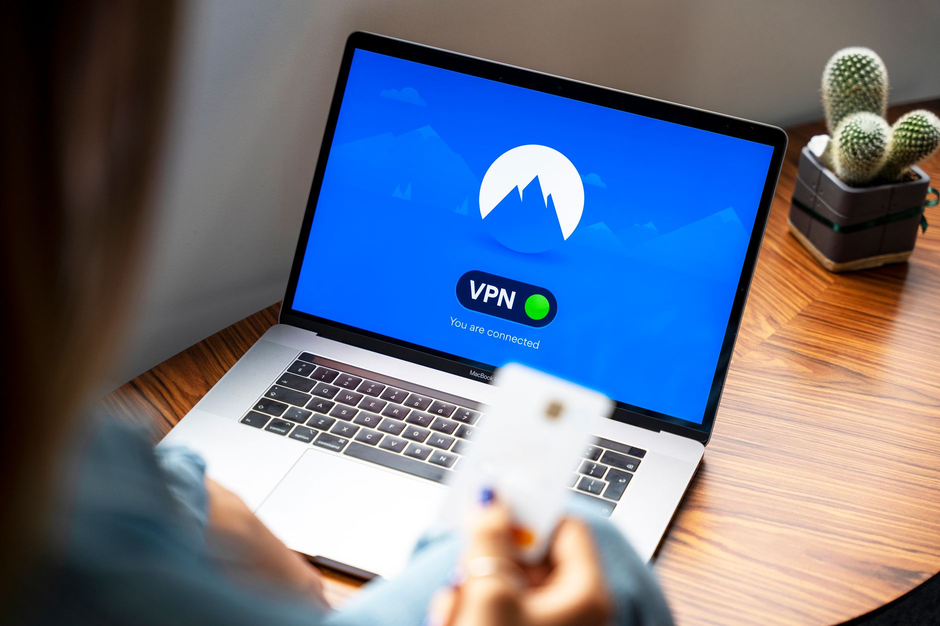 Person using a VPN on a laptop for secure internet browsing while working remotely