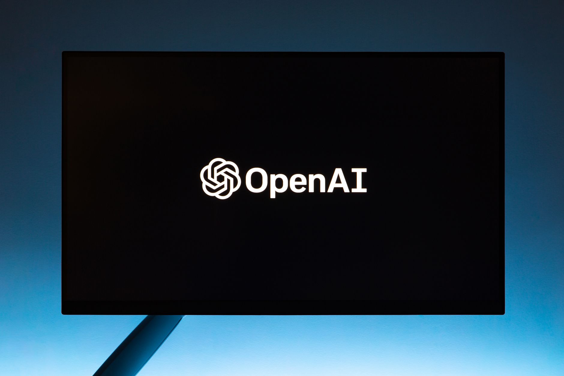 Minimalist display of OpenAI logo on a screen representing AI software interface