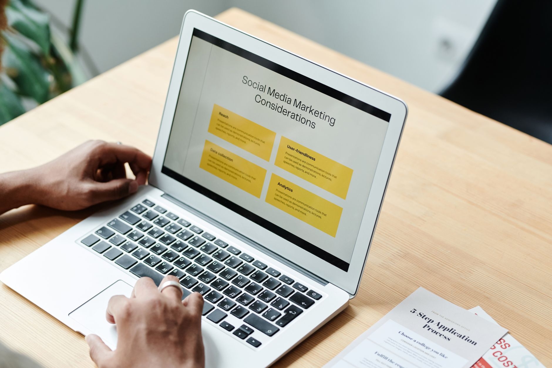 Best AI Writing Tools for US Content Teams 2026 Person using laptop to review content marketing strategies at home — AI-assisted content planning