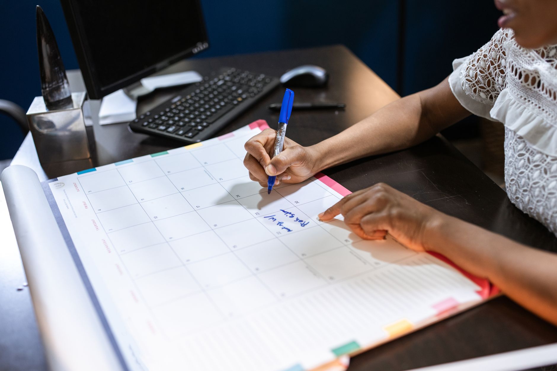 Reclaim AI vs Motion vs Clockwise 2026 Writing notes in a desk calendar for time management and productivity planning