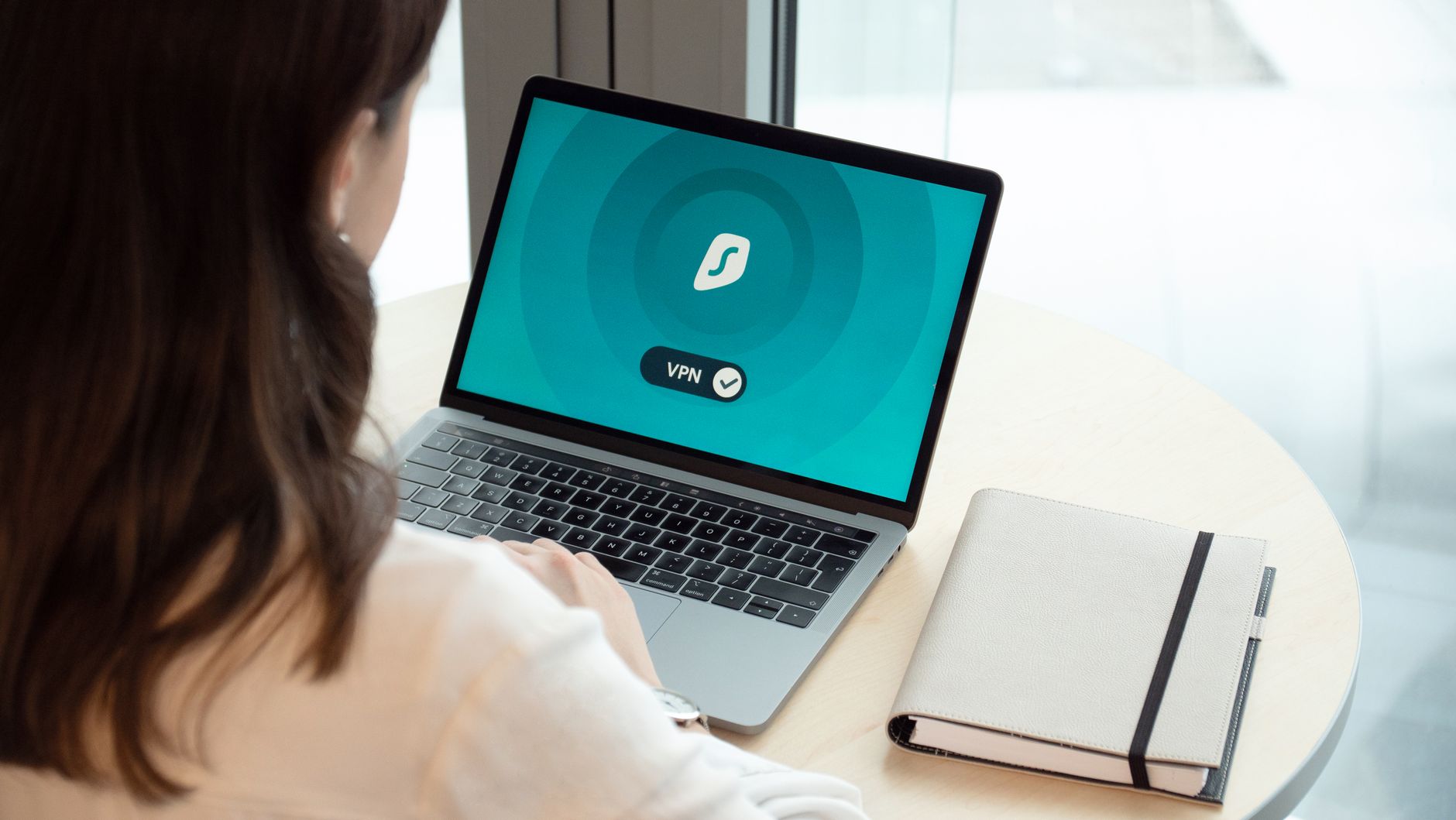 Woman using laptop with VPN for secure private browsing online privacy protection