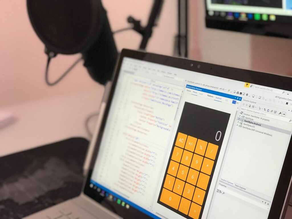 Laptop displaying code in modern workspace representing screen recording and software comparison tools