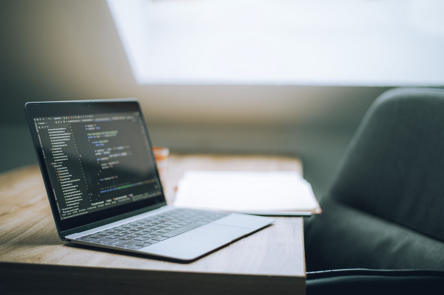 Screen Recording Tools 2026: Loom vs Tella Open laptop displaying code in modern office setting representing tech software tools for professionals