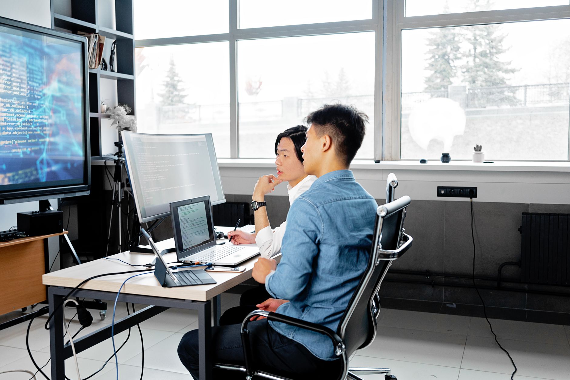 Best AI Code Review Tools for Developers Two developers reviewing code together using AI-assisted code review tools